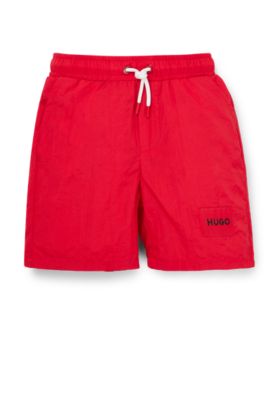 Kids' swim shorts with red logo label, Red