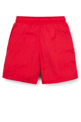 Kids' swim shorts with red logo label, Red