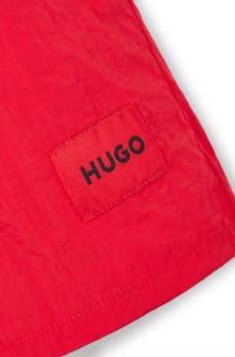 Kids' swim shorts with red logo label, Red