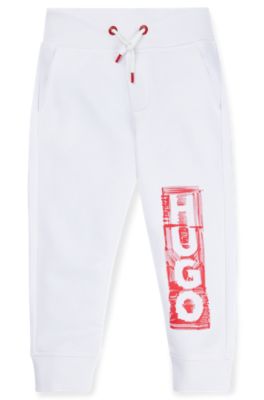 Kids' fleece tracksuit bottoms with marker-style logo, White