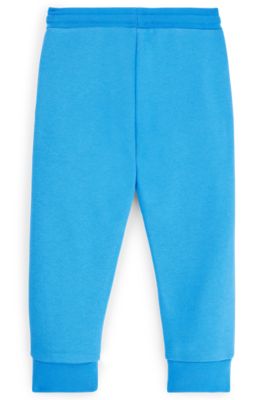 Kids' tracksuit bottoms with vertical logo, Blue