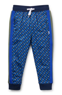 Kids' tracksuit bottoms with printed monograms, Dark Blue