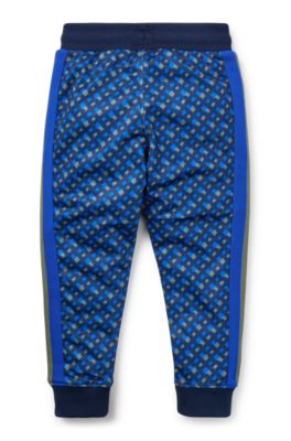 Kids' tracksuit bottoms with printed monograms, Dark Blue