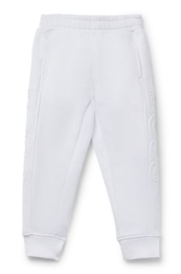 Kids' tracksuit bottoms with embossed logos, White