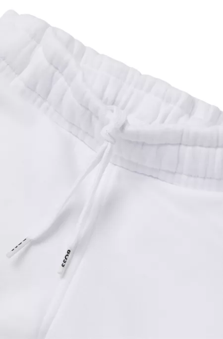 Kids' tracksuit bottoms with embossed logos