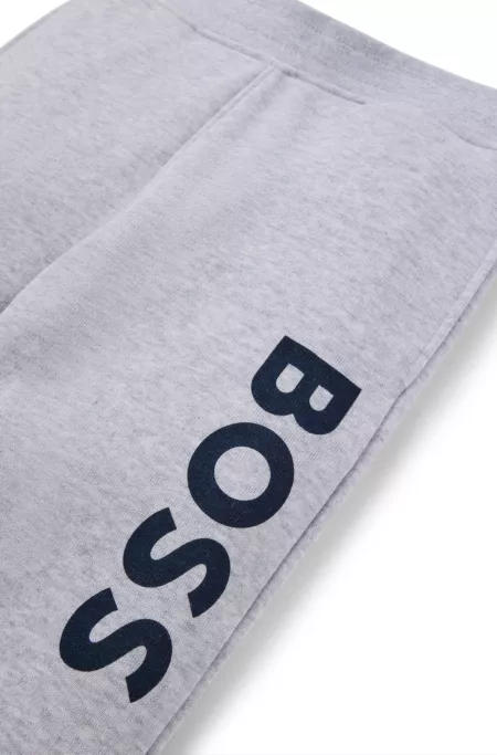 Kids' fleece tracksuit bottoms with vertical logo print