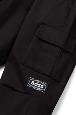 Pantalones tapered fit en sarga de algod&oacute;n el&aacute;stico para ni&ntilde;os, Negro