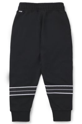 Pantalones de ch&aacute;ndal tapered fit para ni&ntilde;os con ribetes de espiga, Negro