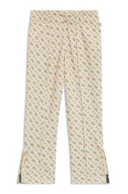 Pantalones de ch&aacute;ndal para ni&ntilde;os con estampado de monograma y cremallera en los bajos, Beige claro