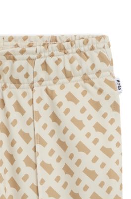 Pantalones de ch&aacute;ndal para ni&ntilde;os con estampado de monograma y cremallera en los bajos, Beige claro