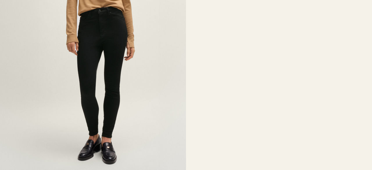 Model wearing a  slim fit jeans trousers showing fit from back and front 