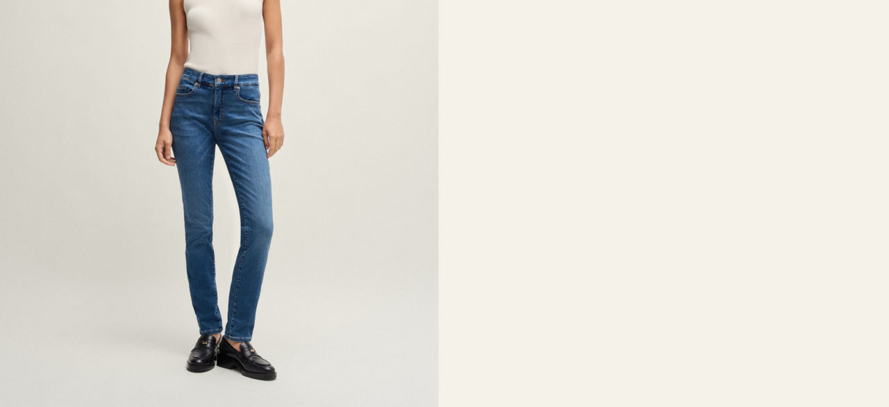 Model wearing a regular fit jeans trousers showing fit from back and front 