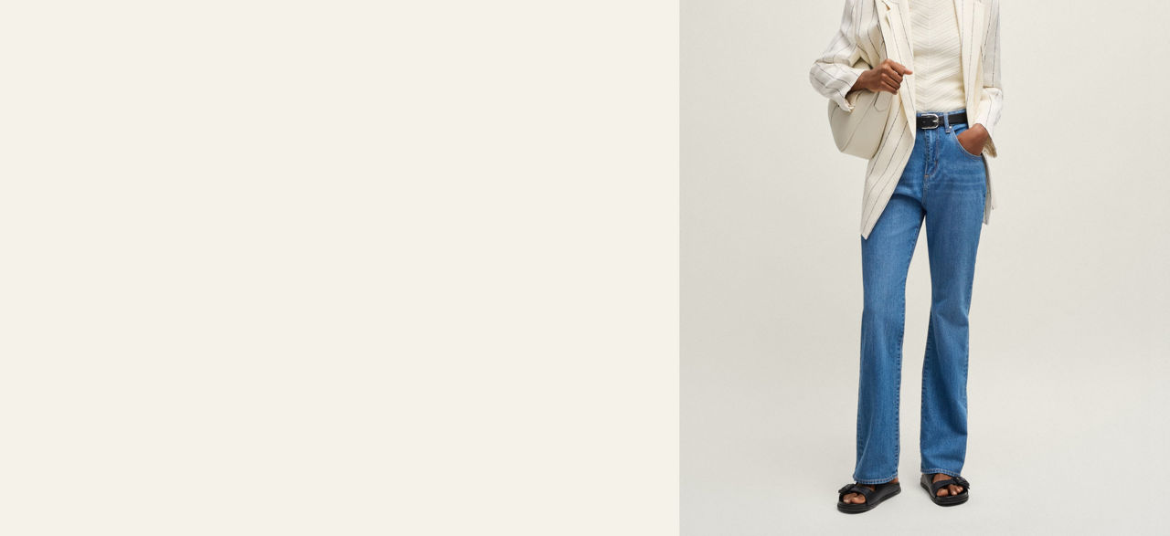 Model wearing a tapered fit jeans trousers showing fit from back and front 