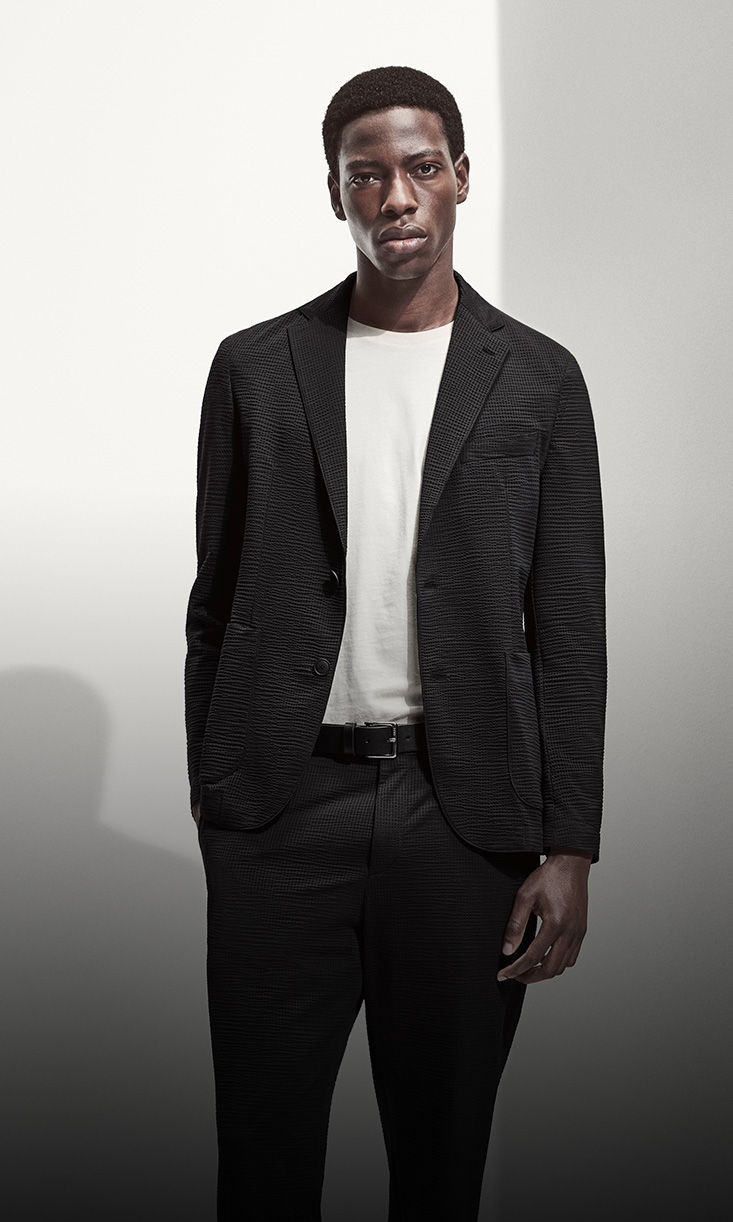 model wearing black suit with white tshirt by boss