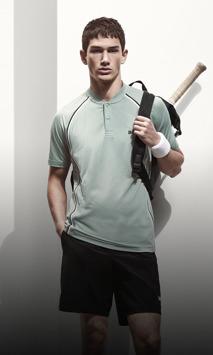 model wearing elevated athleisure wear with tennis racket by boss
