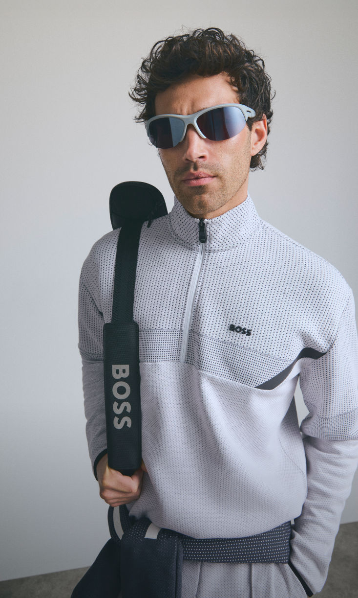 model wearing elevated athleisure wear with tennis racket by boss