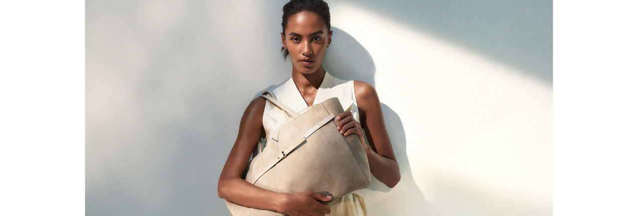 female model holding a bag presenting BOSS Revers