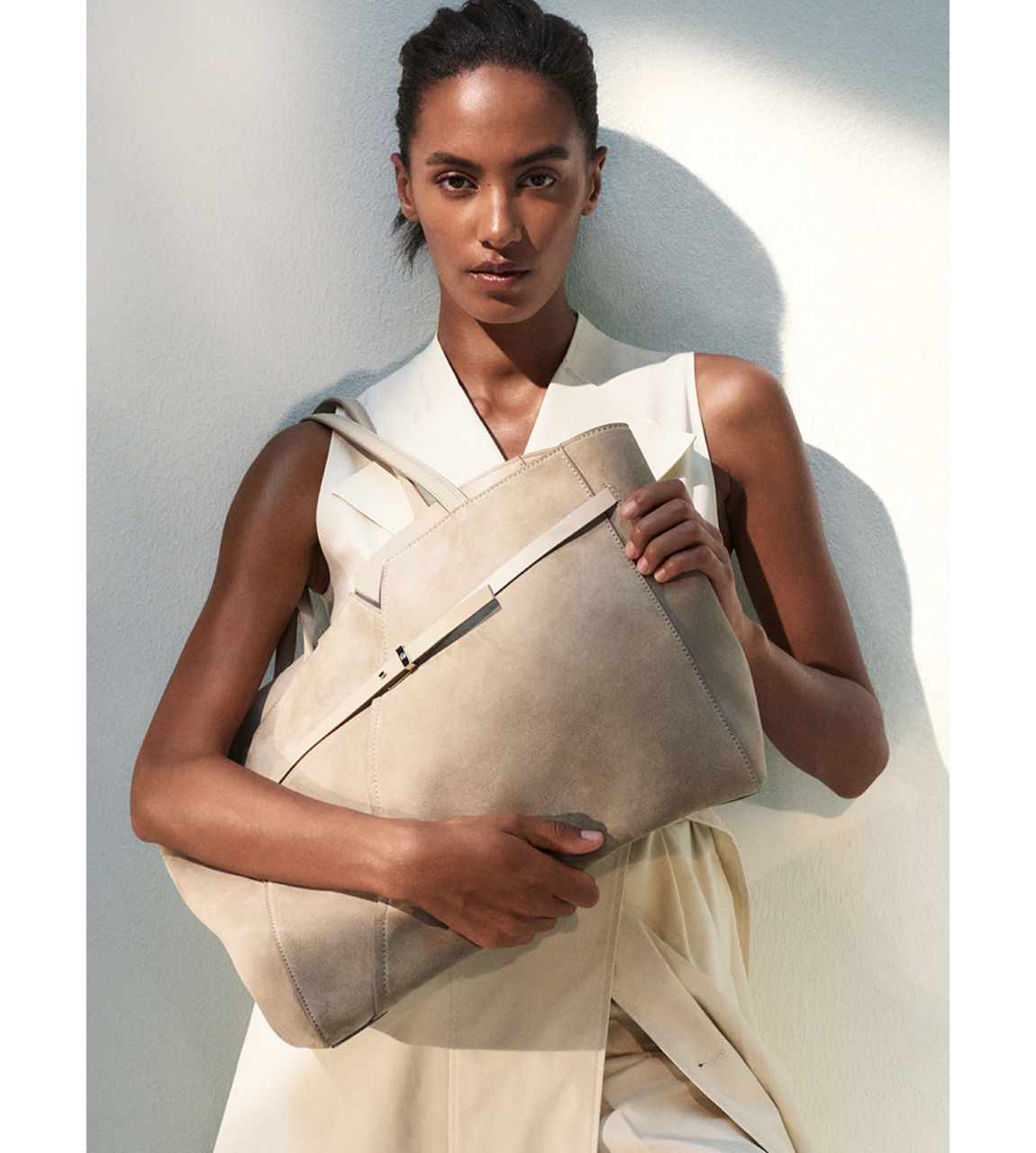 female model holding a bag presenting BOSS Revers