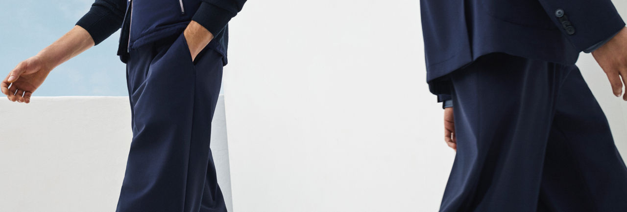 two male models walking in the new BOSS Performance collection in navy blue.