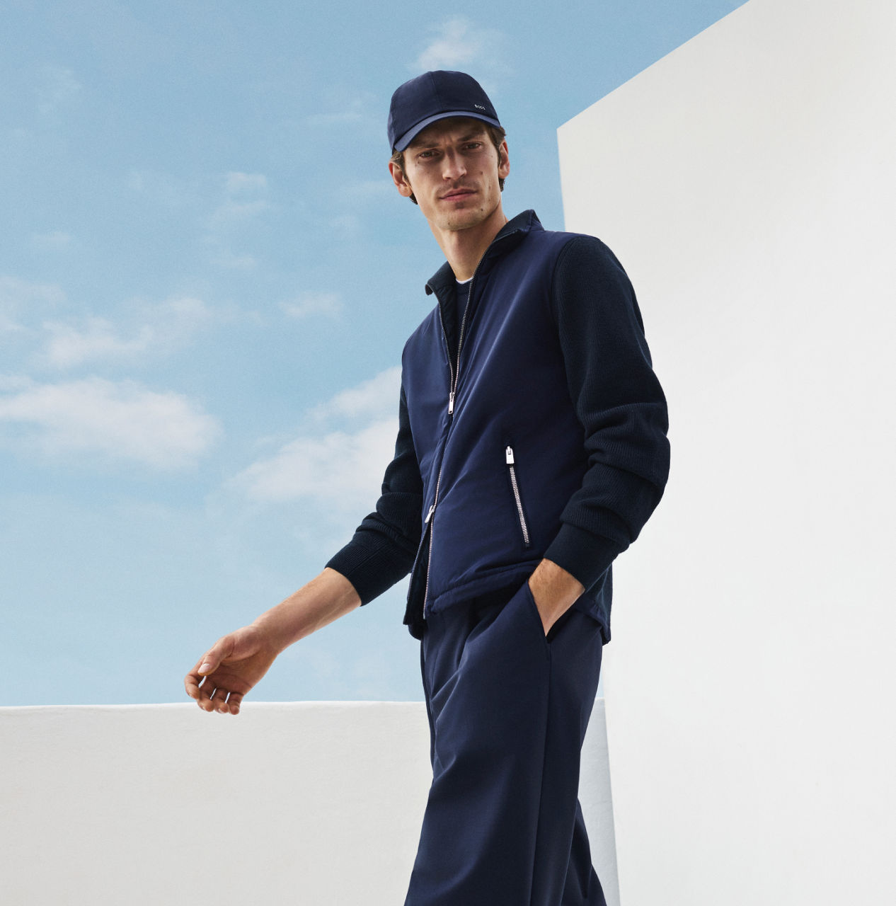 male model in the new BOSS Performance collection with a baseball cap all in navy blue