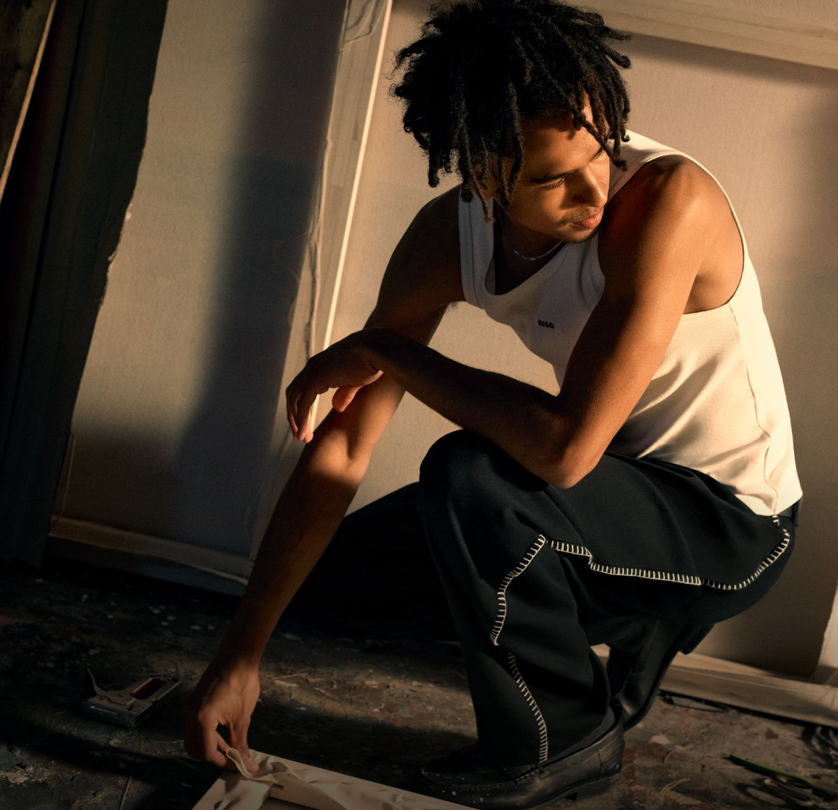 male model wearing tank top and black trousers by HUGO