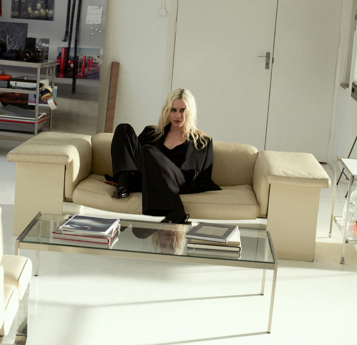 male model wearing a white HUGO tank top and black trousers