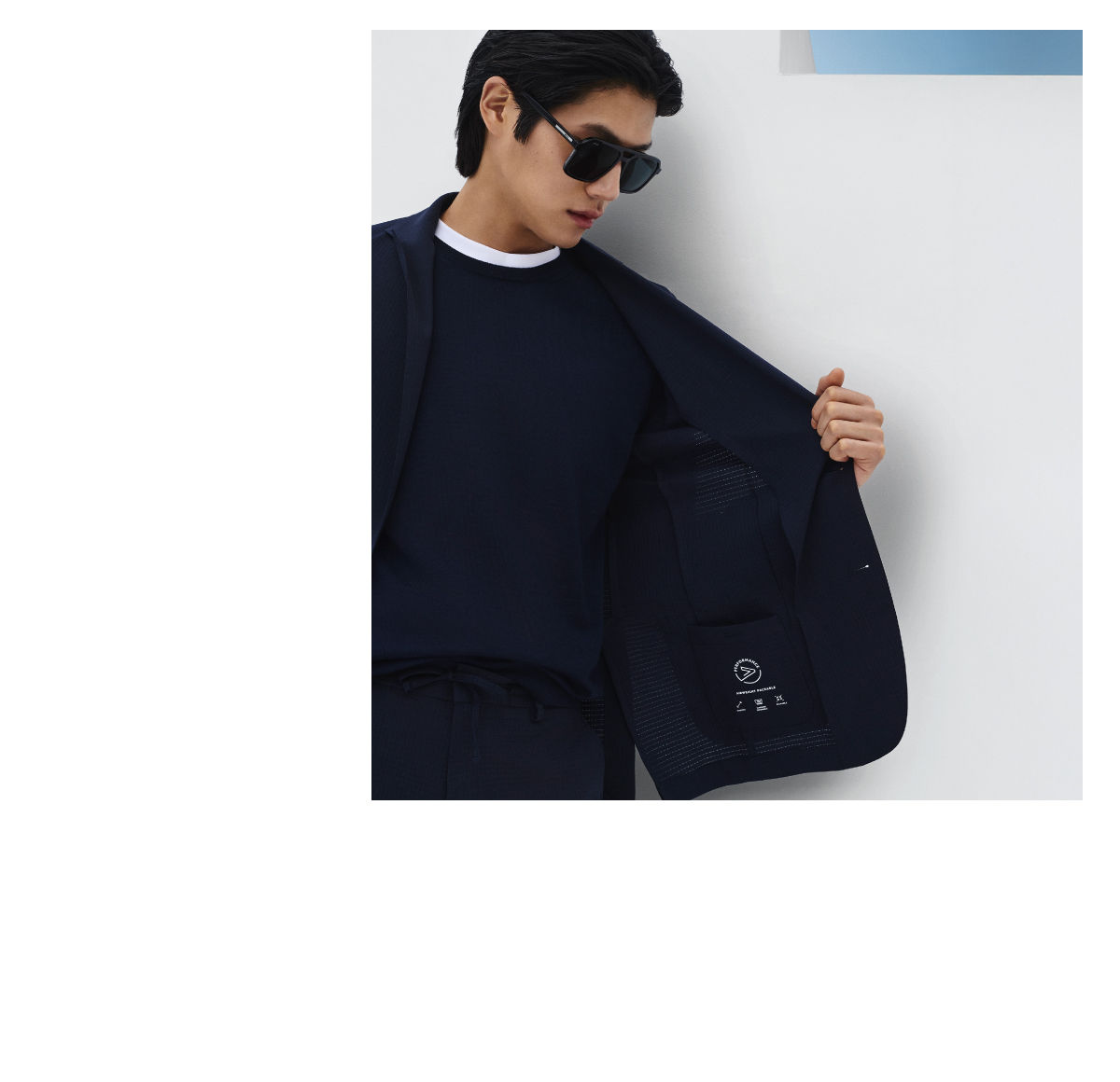 male model opening his BOSS Performance jacket showing the inside