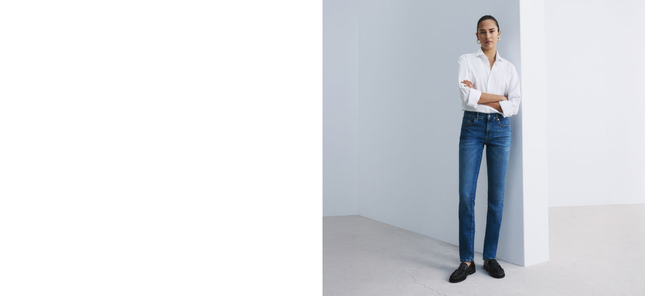 Model wearing a regular fit jeans trousers showing fit from back and front 