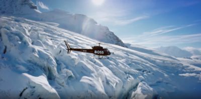 BOSS helicopter flying over mountains