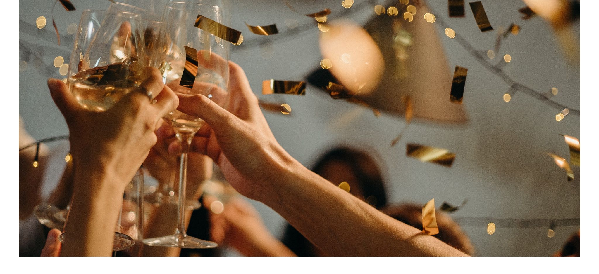 Participants of a party cheering with champagne glasses