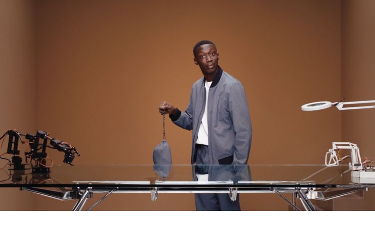 Video of Khaby presenting the new packable BOSS suit from the performance capsule showing how to pack the suit 