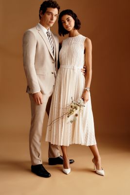 Male and Female model wearing formal beige BOSS attires for wedding occasion