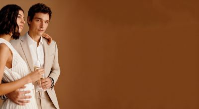 Male and Female model wearing beige BOSS attires for wedding occasion