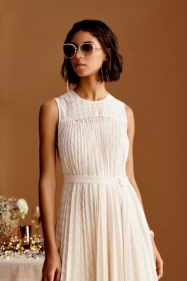 Male and Female model wearing formal beige BOSS attires for wedding occasion