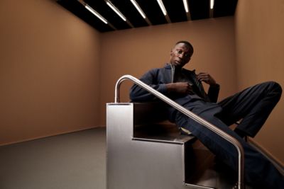 Khaby wearing a casual sportive look, zip jacket and trousers in dark blue 