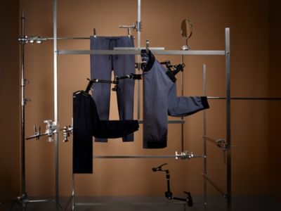 Laydown Image of blue packable suit and black knitwear sweater