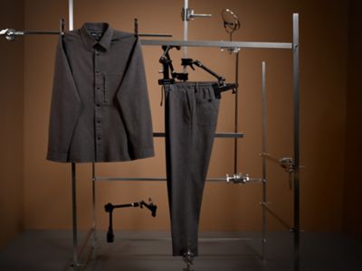 Laydown Image of a grey suit trousers and a wrinkle free grey shirt 