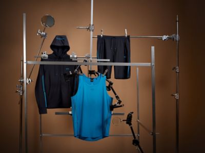 Laydown Image of gym wear featuring a hooded zip jacket, short trousers and a light blue tank top 