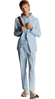 light blue extra slim fit suit with a light blue hooded sweatshirt underneath with a bright orange bumbag for men by BOSS