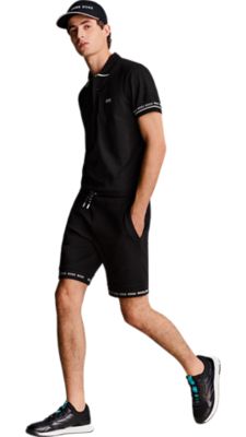 black jersey shorts with a black polo shirt and a black cap for Men by BOSS
