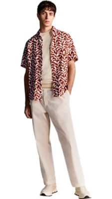 open white trouser with a open with short sleeved knit pullover and a short sleeves shirt with an open brown and white print overneath for men by BOSS