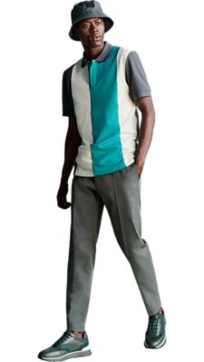 dark green polo shirt with 3 vertikal big stripes in bright blue and white with a dark green trouser and a dark green bucket hat for men by BOSS