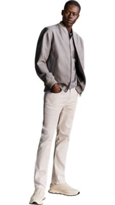 white slim fit jeans with a dark blue polo shirt and a silver bomber jacket for men by BOSS