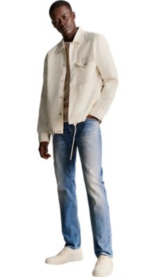 bright blue slim fit stone washed jeans with a open white sweatshirt and a light beige shirt jacket for men by BOSS