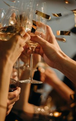 Participants of a party cheering with champagne glasses